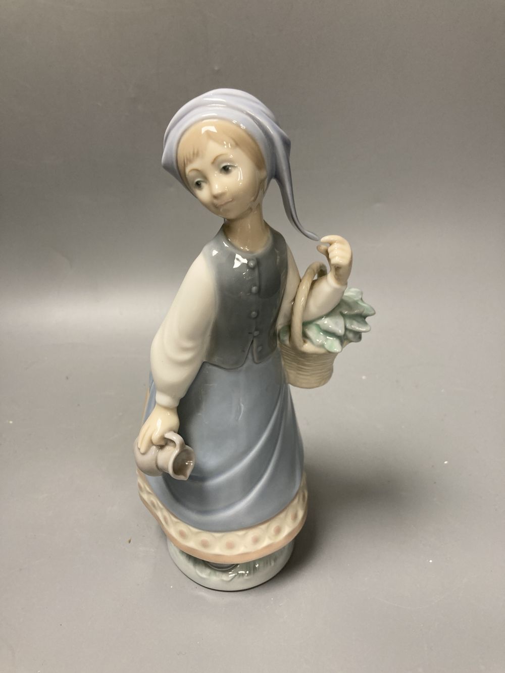 Two Lladro porcelain figures and a Royal Copenhagen model of a seal, tallest 26cm